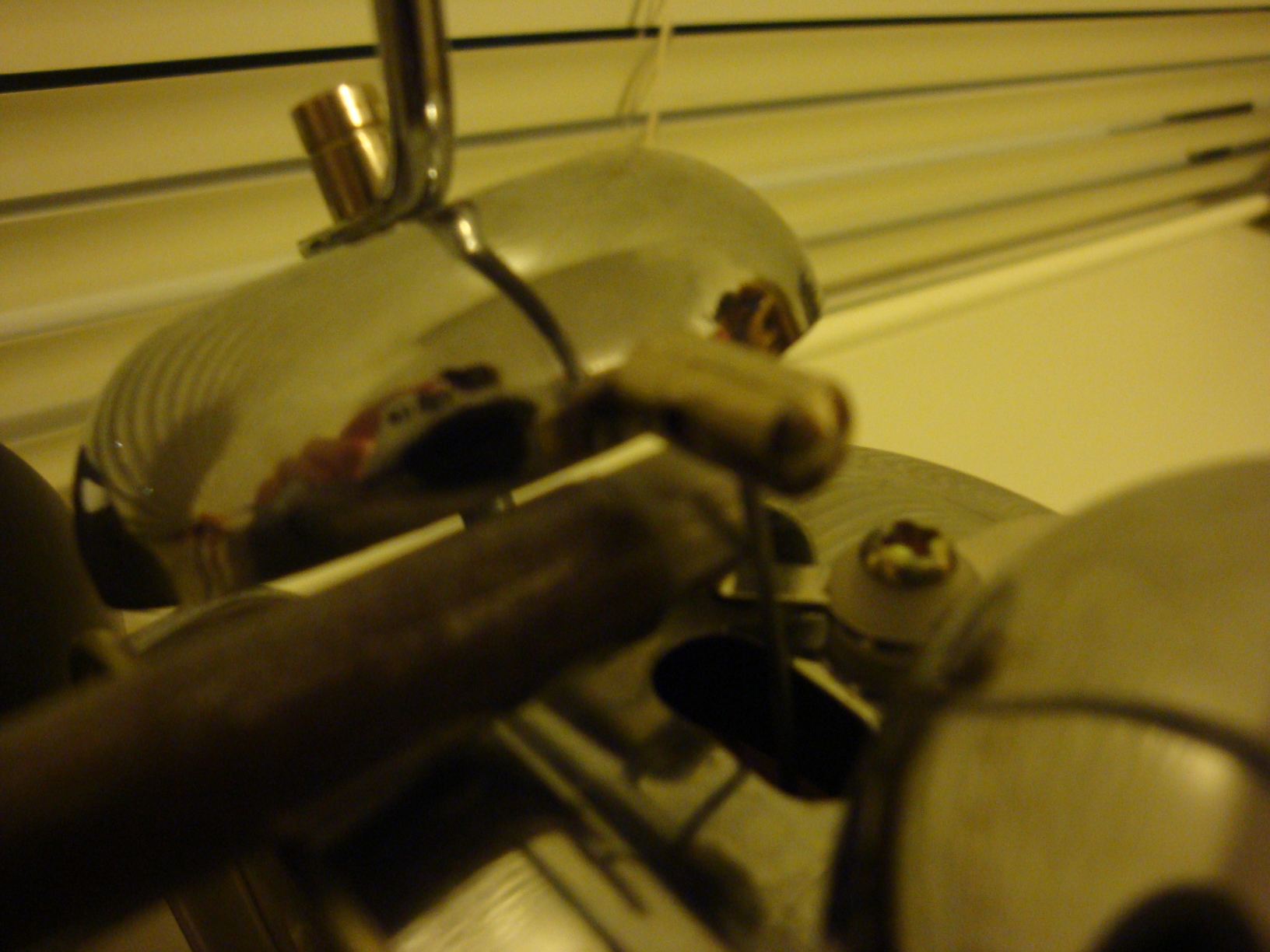 Closeup of the metal rod which is block the hammer that wants to strike the bells.